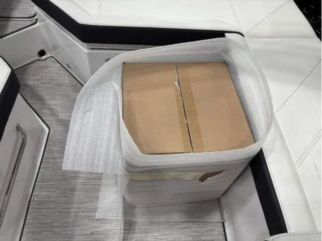 Slide: The Image of Cardboard box on seat in Cobalt R6 boat, 2026 model. - 12
