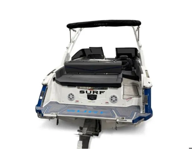 Slide: The Image of Rear view of 2026 Cobalt R4 Surf boat with black canopy. - 4