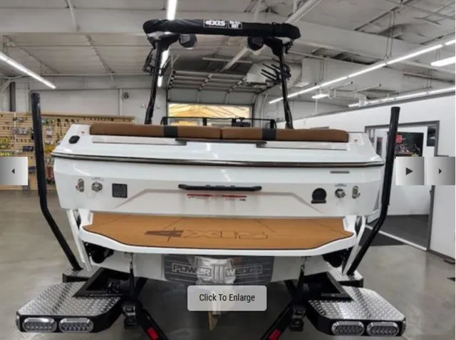 Slide: The Image of Rear view of a 2026 Axis Wake Research A225 boat in a workshop. - 3