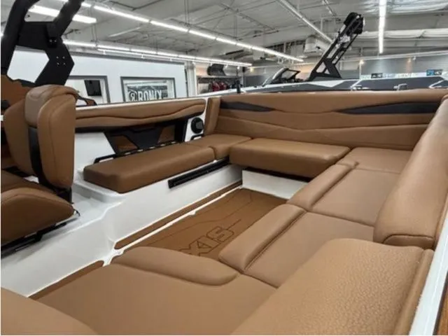 Slide: The Image of Interior of 2026 Axis Wake Research A225 boat with brown leather seating. - 6