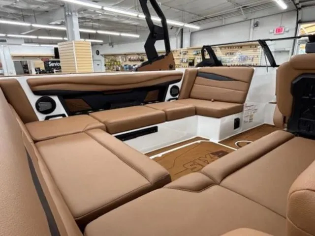 Slide: The Image of Interior of 2026 Axis Wake Research A225 boat with brown leather seating. - 7