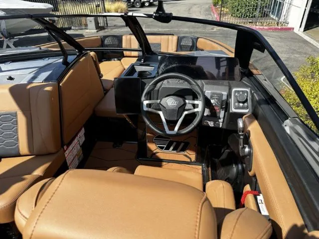 Slide: The Image of Interior of 2026 Malibu Wakesetter 23 MXZ with brown leather seats. - 8