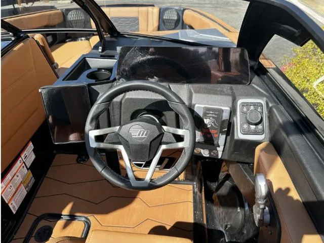 Slide: The Image of Interior of 2026 Malibu Wakesetter 23 MXZ with modern steering wheel. - 9