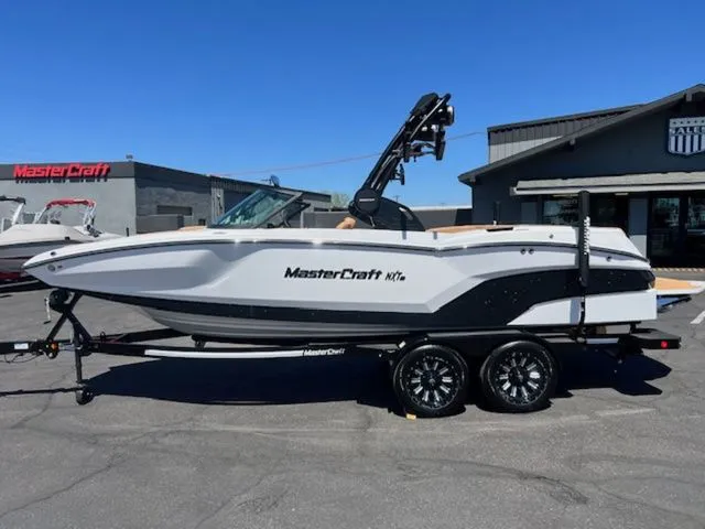 The Image of 2026 MasterCraft NXT22 boat on trailer outdoors. - 1