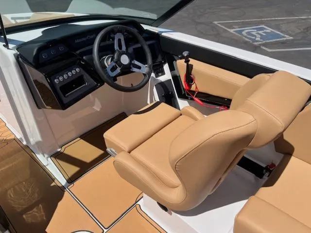 Slide: The Image of Interior of a 2026 MasterCraft NXT22 boat with beige leather seating. - 13