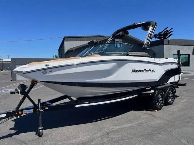 Slide: The Image of 2026 MasterCraft NXT22 boat on trailer, side view. - 2