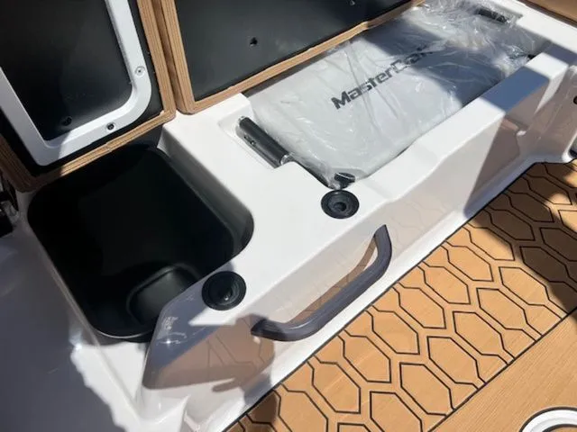 Slide: The Image of Interior of 2026 MasterCraft NXT22 with storage and wood details. - 22