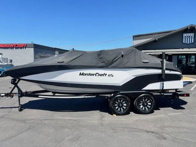 Slide: The Image of 2026 MasterCraft NXT22 boat with cover on trailer. - 23