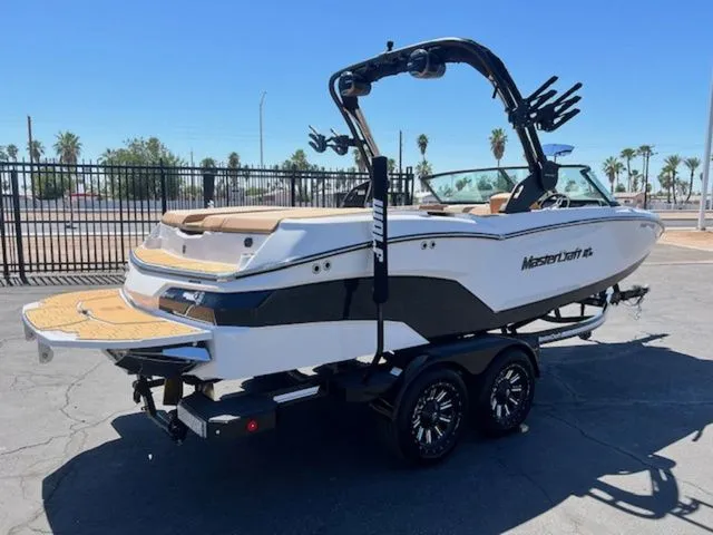 Slide: The Image of 2026 MasterCraft NXT22 boat on trailer, ready for watersports. - 6