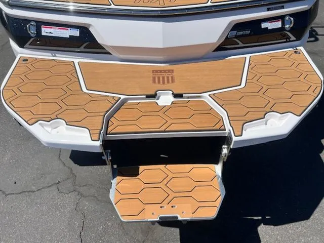 Slide: The Image of 2026 MasterCraft NXT22 swim platform with wood finish and modern design. - 7