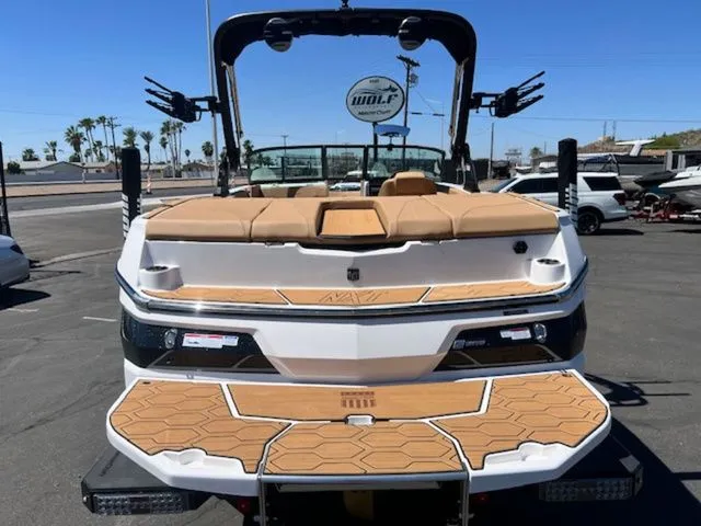 Slide: The Image of Rear view of a 2026 MasterCraft NXT22 boat in a parking lot. - 8