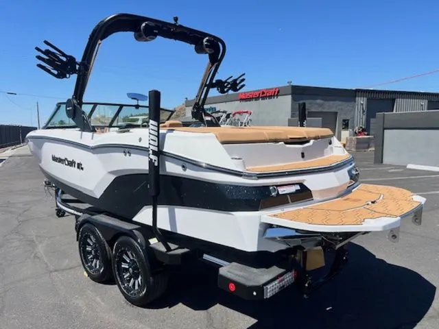 Slide: The Image of 2026 MasterCraft NXT22 boat on trailer, side view. - 9
