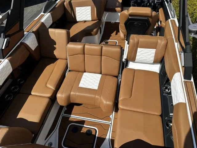 Slide: The Image of Interior of 2026 Malibu Wakesetter 24 MXZ with brown leather seating. - 12