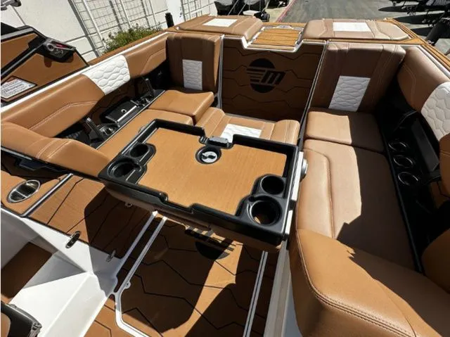 Slide: The Image of 2026 Malibu Wakesetter 24 MXZ interior with seating and table. - 13