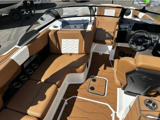 Slide: The Image of Interior of 2026 Malibu Wakesetter 24 MXZ with brown leather seating. - 6