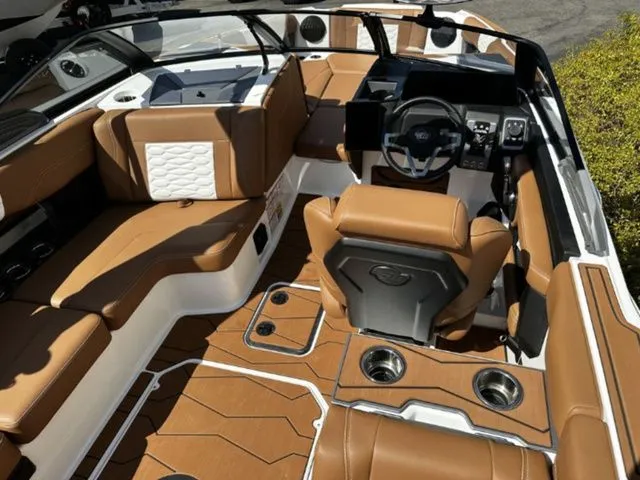 Slide: The Image of Interior of 2026 Malibu Wakesetter 24 MXZ with brown leather seating. - 7