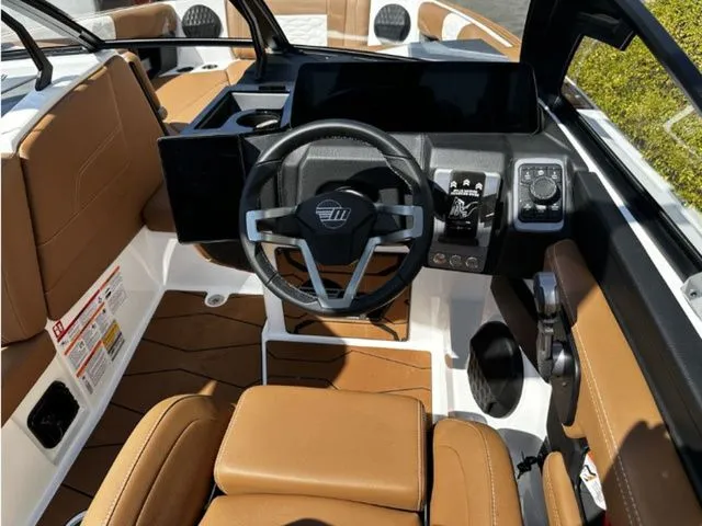 Slide: The Image of 2026 Malibu Wakesetter 24 MXZ interior with brown leather seats. - 8