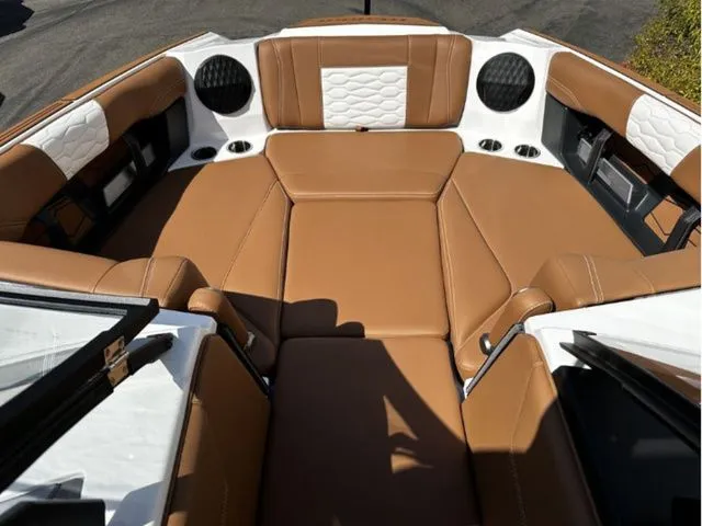 Slide: The Image of 2026 Malibu Wakesetter 24 MXZ interior with brown leather seating. - 9