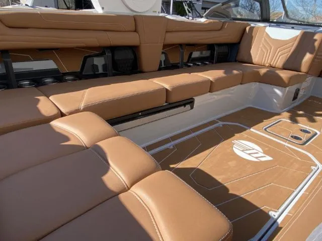 Slide: The Image of Interior of 2026 Malibu Wakesetter 25 LSV with brown leather seating. - 14