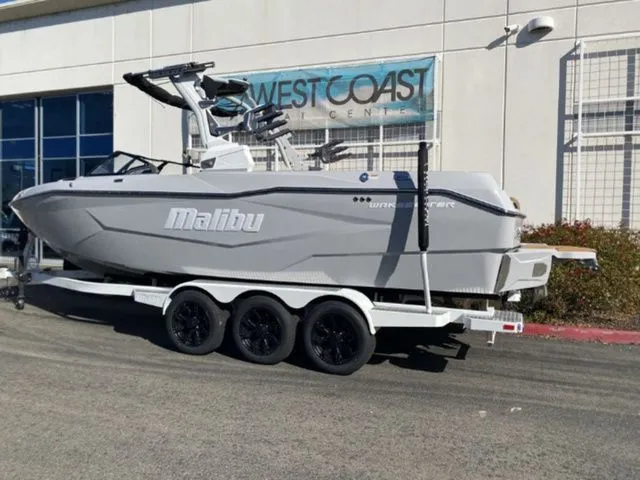 Slide: The Image of 2026 Malibu Wakesetter 25 LSV boat on trailer outside building. - 3