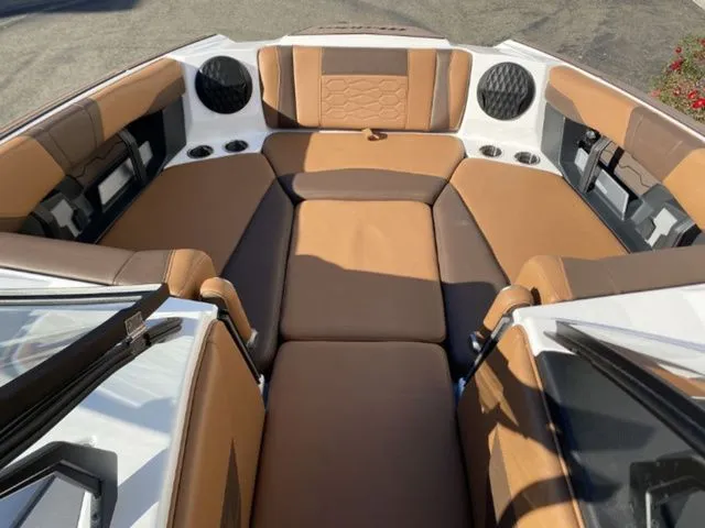 Slide: The Image of Interior of 2026 Malibu Wakesetter 23 MXZ with brown upholstery. - 11