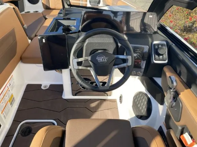 Slide: The Image of Interior of 2026 Malibu Wakesetter 23 MXZ with modern steering wheel. - 12