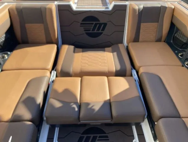 Slide: The Image of 2026 Malibu Wakesetter 23 MXZ interior with brown upholstery. - 15