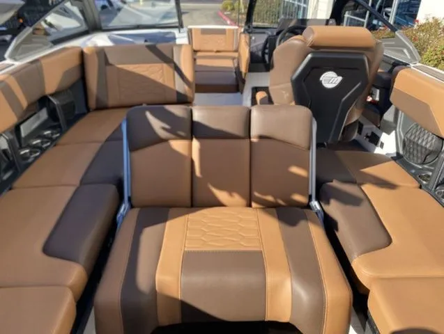 Slide: The Image of Interior of 2026 Malibu Wakesetter 23 MXZ with luxurious brown seating. - 16