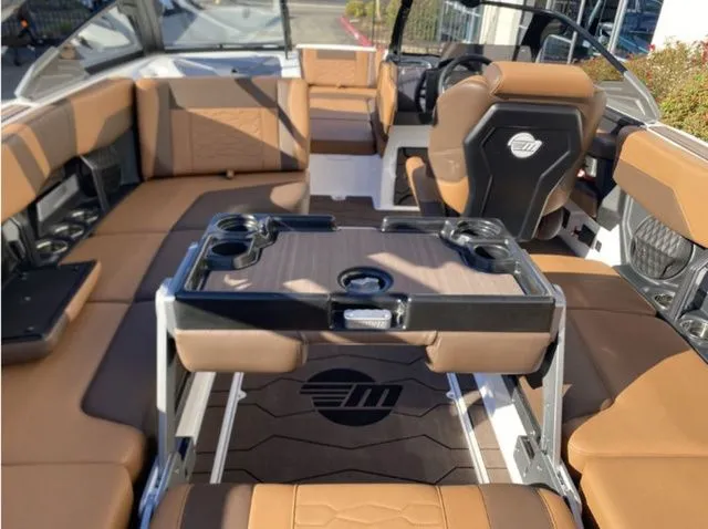 Slide: The Image of Interior of 2026 Malibu Wakesetter 23 MXZ with brown leather seating. - 17