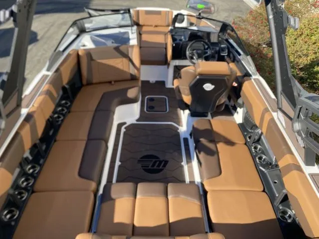 Slide: The Image of Interior of 2026 Malibu Wakesetter 23 MXZ with brown leather seating. - 8