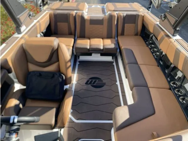 Slide: The Image of Interior of 2026 Malibu Wakesetter 23 MXZ with luxurious brown seating. - 9