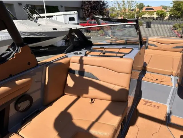 Slide: The Image of Interior of Axis Wake Research T235 boat, 2026 model, featuring beige leather seats. - 8