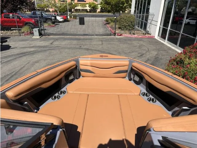 Slide: The Image of Interior of 2026 Axis Wake Research T235 boat with brown leather seating. - 9