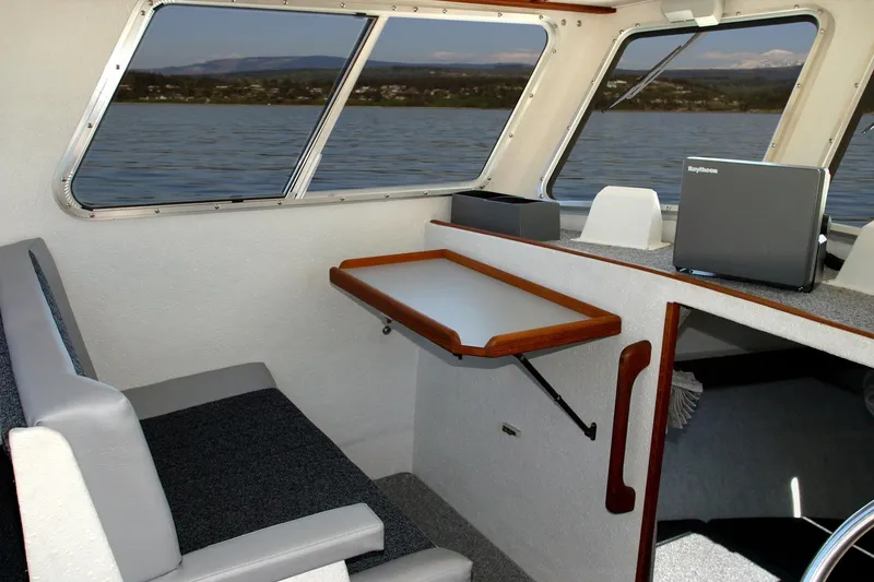 Slide: The Image of Interior of 2026 Sea N Sport Alaskan Pilot 2600 boat with seating and navigation equipment. - 3