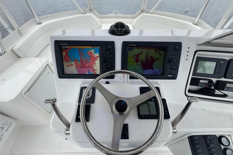 Slide: The Image of Cockpit of 2009 Ocean Yachts 42 Super Sport with navigation screens and steering wheel. - 14
