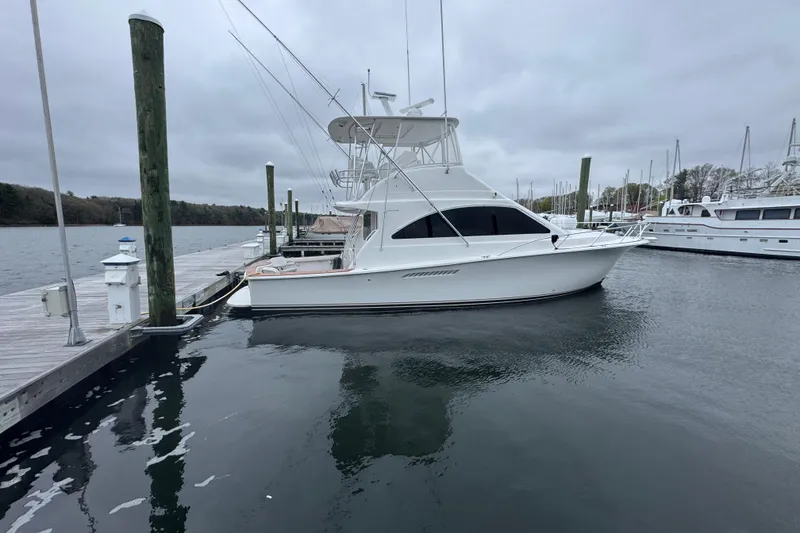 Slide: The Image of 2009 Ocean Yachts 42 Super Sport docked at a marina on a cloudy day. - 2