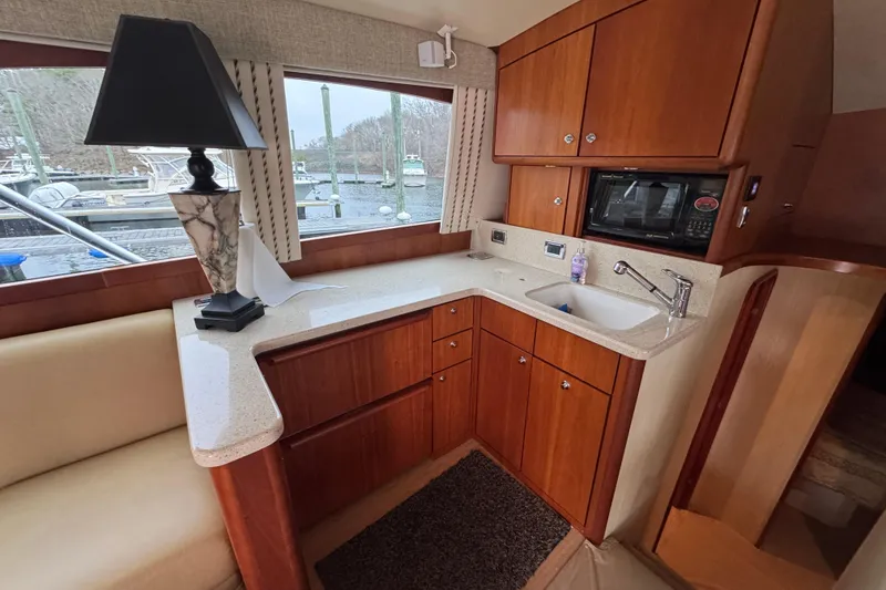 Slide: The Image of Luxurious kitchen interior of 2009 Ocean Yachts 42 Super Sport with wood cabinetry and modern amenities. - 5