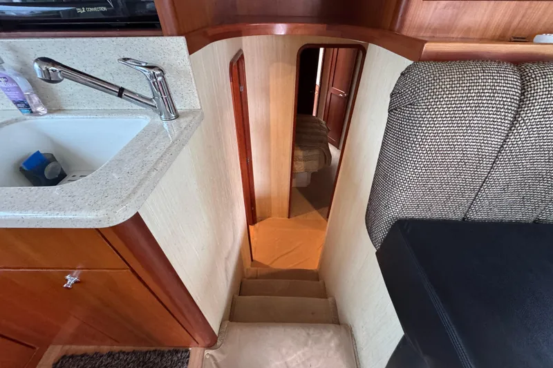 Slide: The Image of Interior view of 2009 Ocean Yachts 42 Super Sport, featuring stairs and a compact kitchen area. - 8