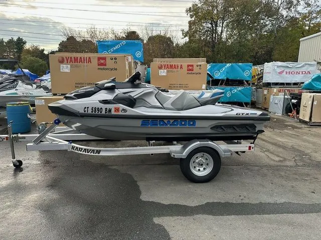 The Image of 2021 Sea-Doo GTX jet ski on trailer parked outdoors. - 1