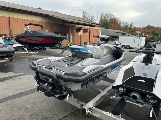 Slide: The Image of 2021 Sea-Doo GTX jet ski parked on a trailer outdoors. - 6