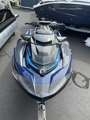 Slide: The Image of 2024 Sea-Doo GTX jet ski in blue on a parking lot. - 2