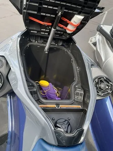 Slide: The Image of 2024 Sea-Doo GTX storage compartment with open lid and accessories. - 6