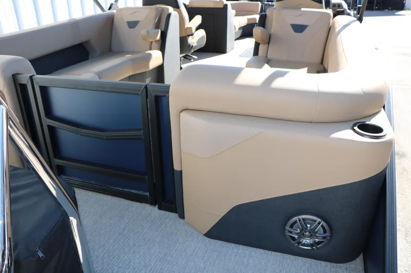 Slide: The Image of Interior of 2026 Evotti 525 QL Tri-Toon boat with beige seating and speaker. - 26