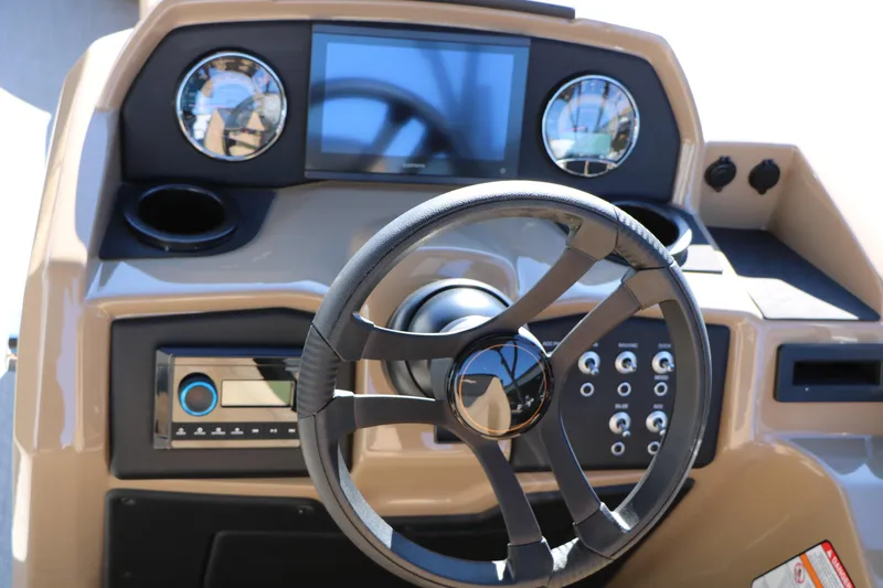 Slide: The Image of Steering console of 2026 Evotti 525 QL Tri-Toon boat with modern controls and gauges. - 29