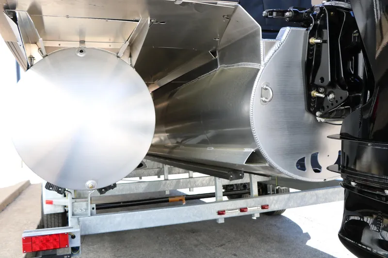 Slide: The Image of 2026 Evotti 525 QL Tri-Toon pontoon boat underside on trailer. - 46