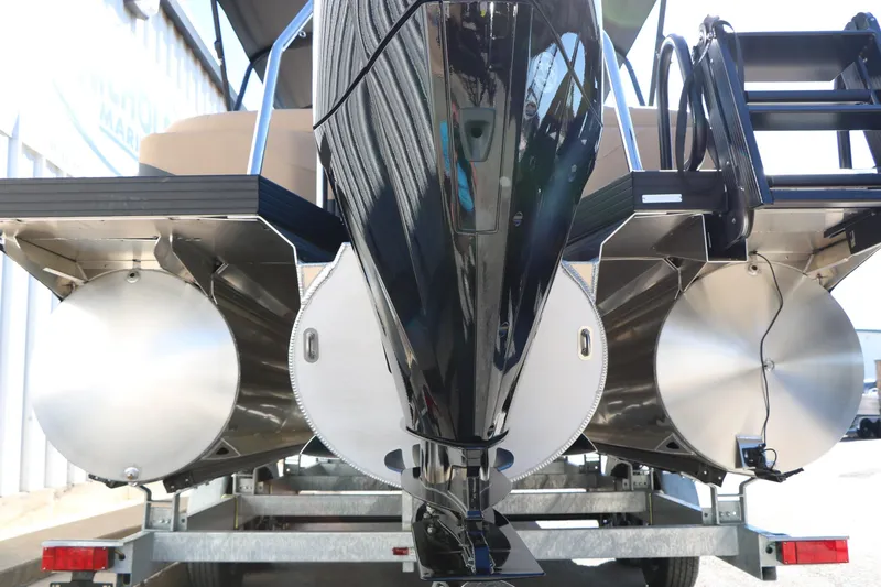 Slide: The Image of 2026 Evotti 525 QL Tri-Toon boat on trailer, showcasing triple pontoon design. - 48