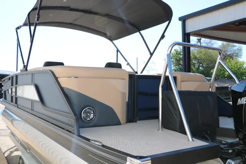 Slide: The Image of 2026 Evotti 525 QL Tri-Toon boat with canopy and sleek design, docked outdoors. - 8