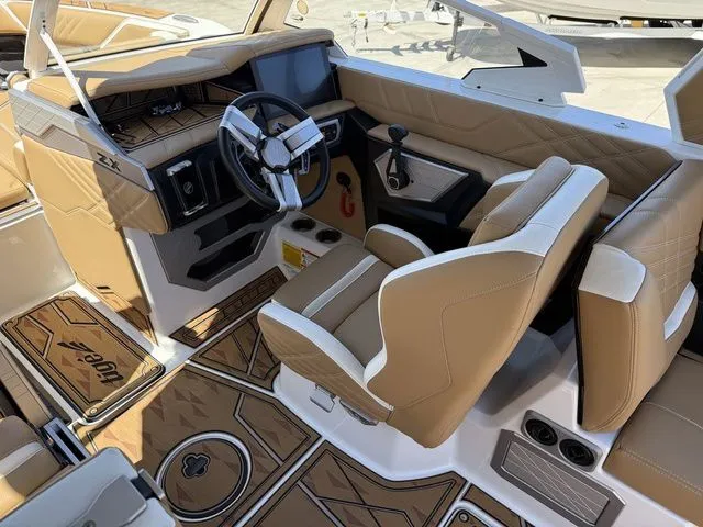 Slide: The Image of Interior of 2025 Tigé 25ZX with luxurious brown leather and modern cockpit. - 11