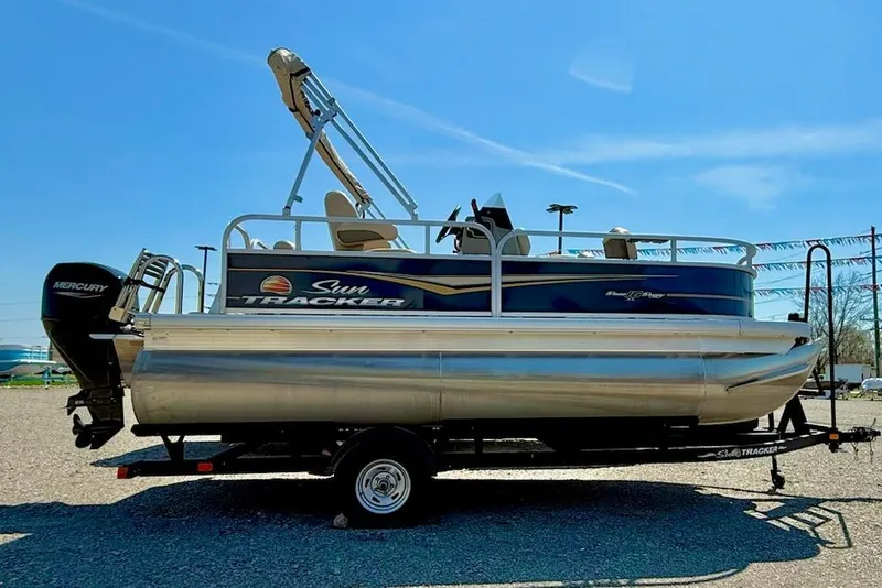 The Image of 2024 Sun Tracker Bass Buggy 16 XL pontoon boat on trailer, side view. - 1