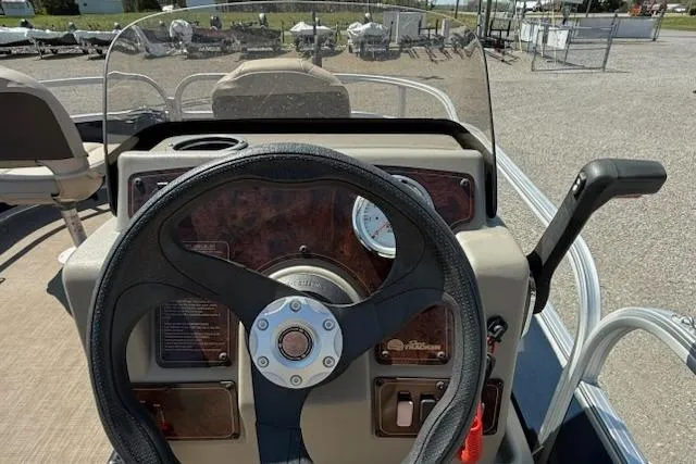 Slide: The Image of 2024 Sun Tracker Bass Buggy 16 XL steering console with controls and gauges. - 6